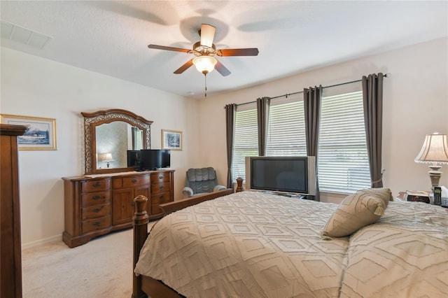 bedroom with ceiling fan and light carpet