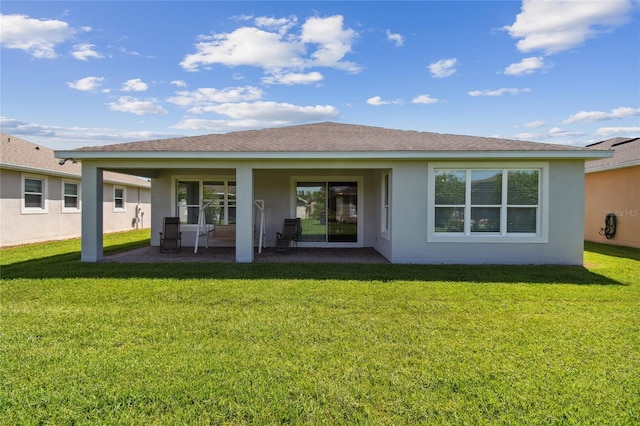 rear view of property featuring a yard