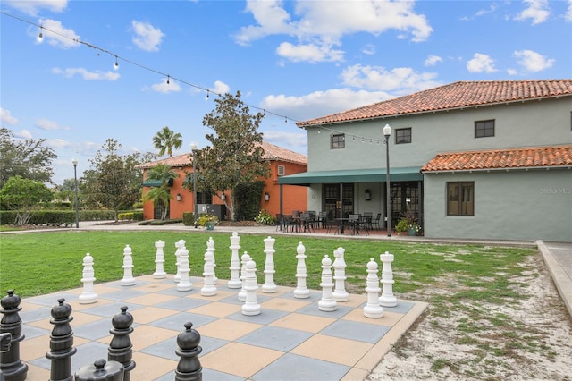 rear view of property featuring a patio area and a lawn