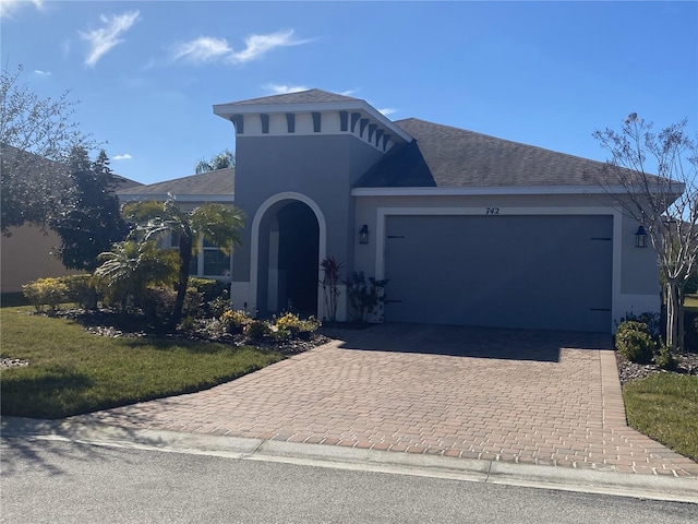 view of front of property featuring a garage and a front yard