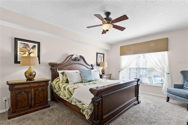 bedroom with ceiling fan, light carpet, and a textured ceiling