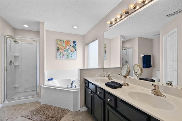 full bathroom with tile patterned flooring, vanity, plus walk in shower, a textured ceiling, and toilet