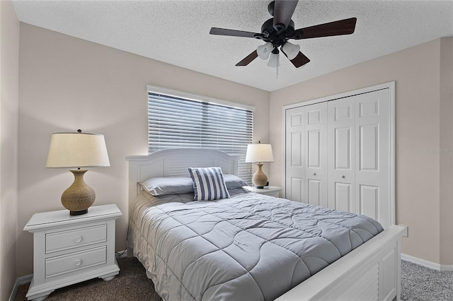 carpeted bedroom with a textured ceiling, ceiling fan, and a closet