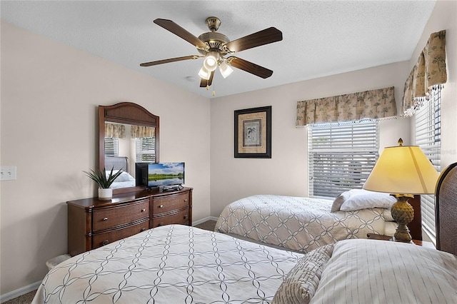 bedroom featuring a textured ceiling and ceiling fan