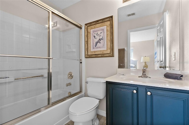 full bathroom with vanity, toilet, and combined bath / shower with glass door