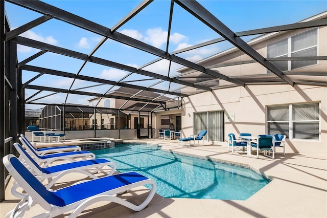 view of pool with an in ground hot tub, a lanai, and a patio area