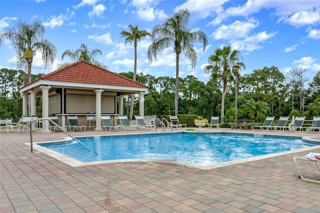 view of pool with a gazebo, an outdoor bar, and a patio area