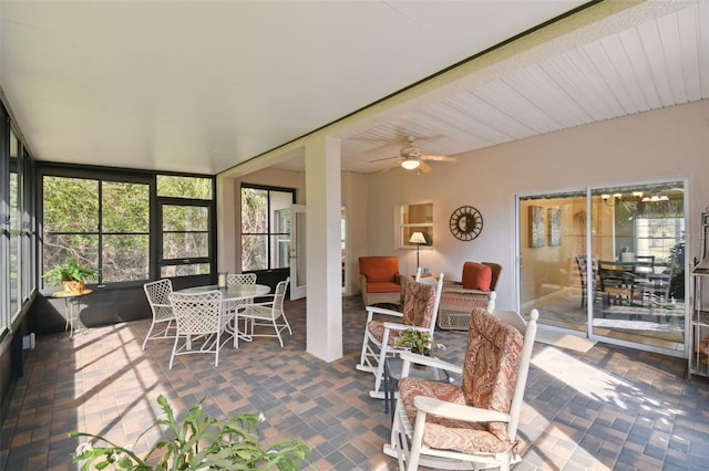 sunroom featuring ceiling fan