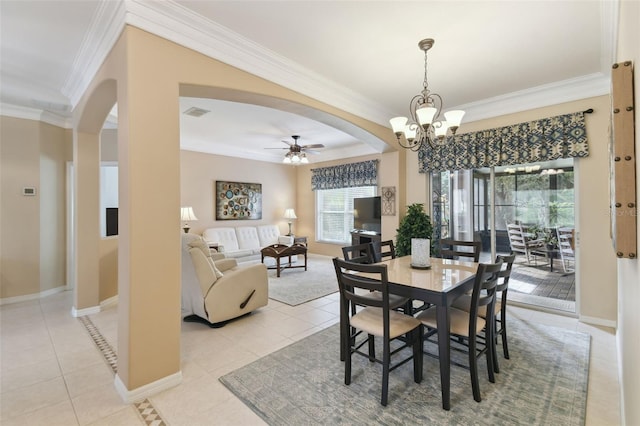 tiled dining space with ornamental molding and ceiling fan with notable chandelier