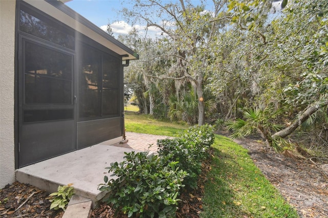 view of yard with a sunroom and a patio area