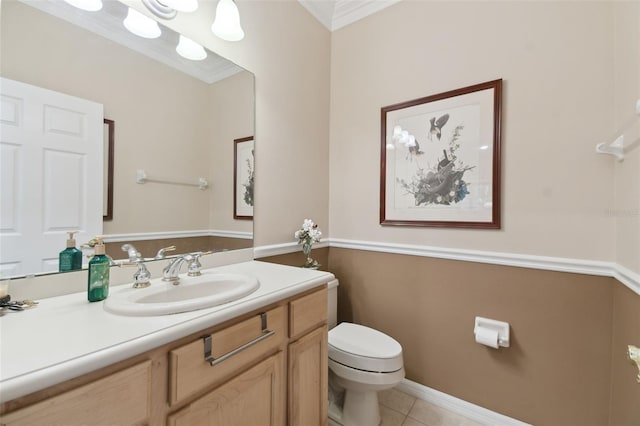 bathroom featuring tile patterned flooring, vanity, ornamental molding, and toilet