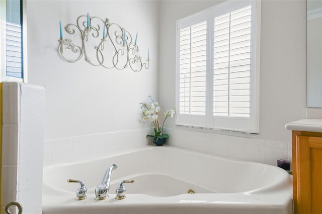 bathroom with vanity and a tub