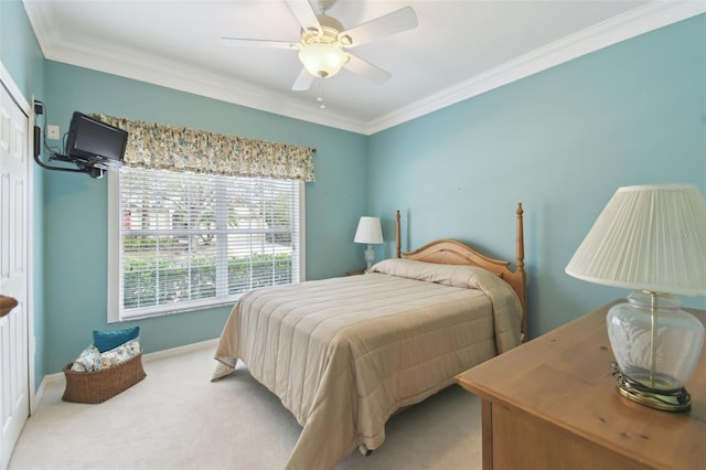 carpeted bedroom featuring crown molding and ceiling fan