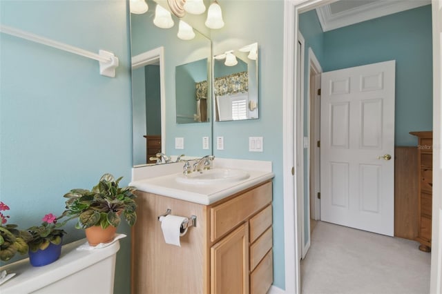 bathroom featuring crown molding, vanity, and toilet