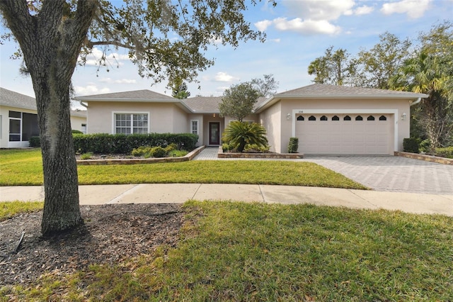 ranch-style house featuring a garage and a front yard