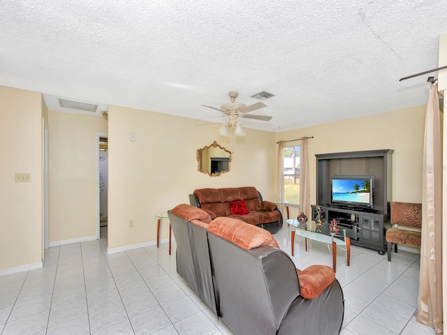 living room with light tile patterned floors, a textured ceiling, and ceiling fan