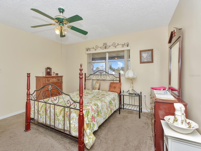 carpeted bedroom featuring a textured ceiling and ceiling fan