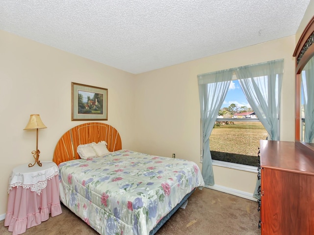 bedroom featuring carpet floors and a textured ceiling