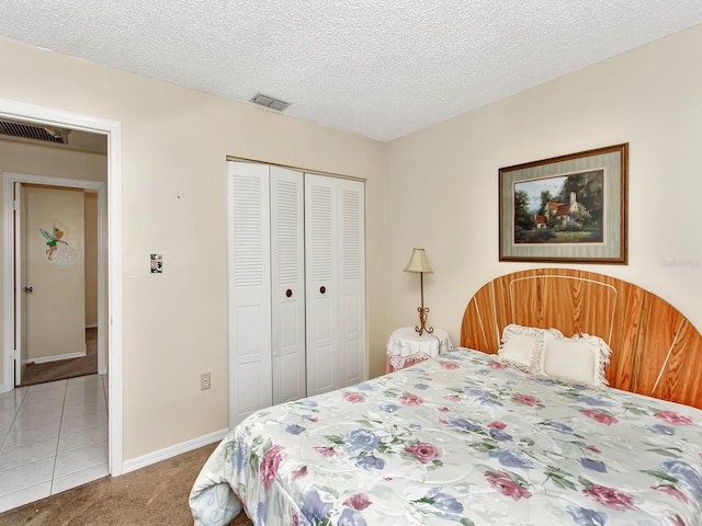 carpeted bedroom featuring a closet and a textured ceiling