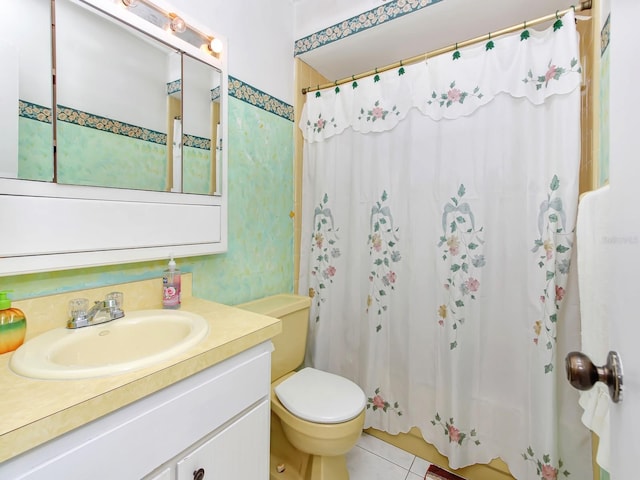 bathroom with tile patterned floors, vanity, toilet, and curtained shower