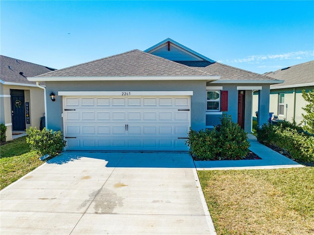 ranch-style house featuring a garage and a front lawn