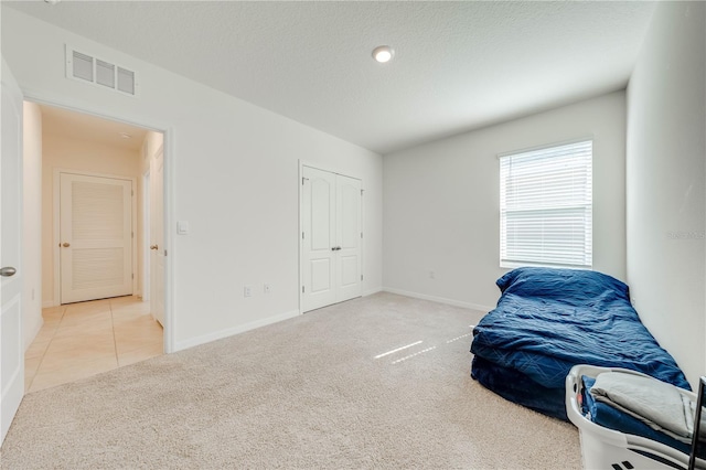 2265 Tay Wes Dr, Saint Cloud, FL 34771 - carpeted bedroom with a closet and a textured ceiling