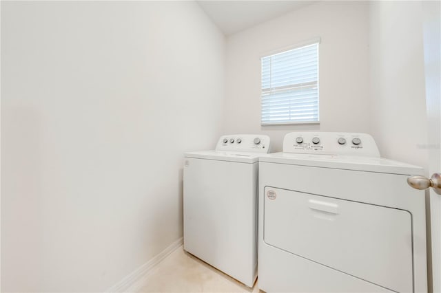 2265 Tay Wes Dr, Saint Cloud, FL 34771 - clothes washing area with washer and dryer and light tile patterned floors
