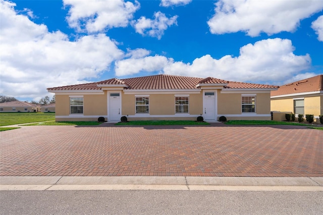 mediterranean / spanish-style home with a front lawn