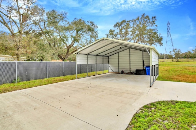 view of parking / parking lot featuring a lawn and a carport