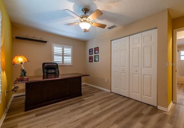 office area with hardwood / wood-style flooring, a textured ceiling, and ceiling fan