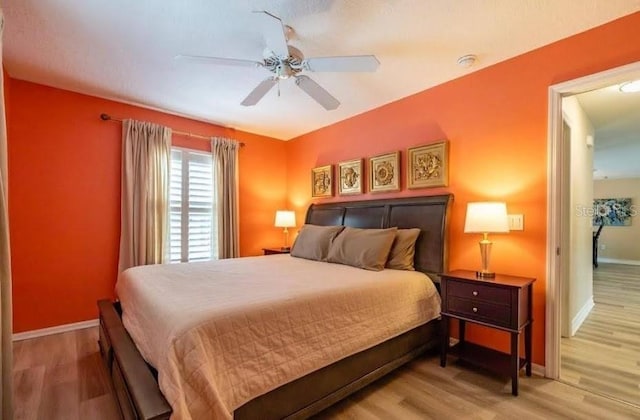 bedroom with ceiling fan and light hardwood / wood-style floors