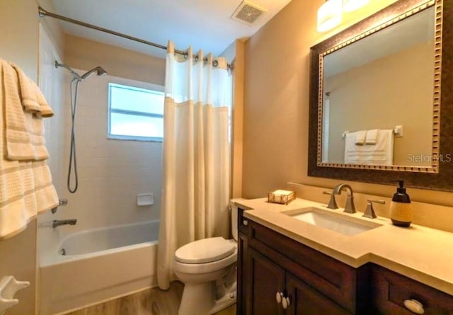full bathroom featuring toilet, vanity, shower / bathtub combination with curtain, and hardwood / wood-style floors