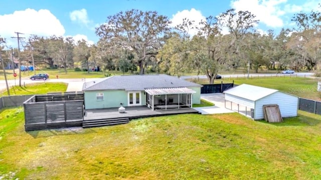 rear view of property with a deck and a lawn