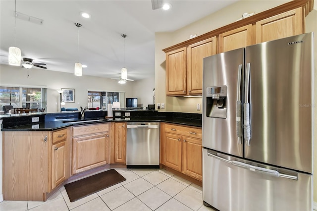 kitchen featuring sink, light tile patterned floors, dark stone countertops, ceiling fan, and stainless steel appliances