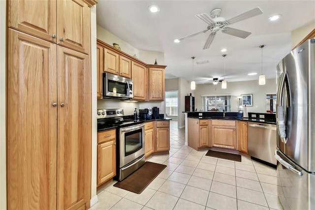 kitchen with light tile patterned flooring, decorative light fixtures, appliances with stainless steel finishes, kitchen peninsula, and ceiling fan