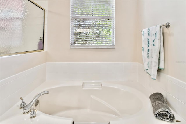 bathroom with a tub to relax in