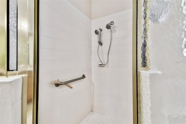 bathroom with a tile shower