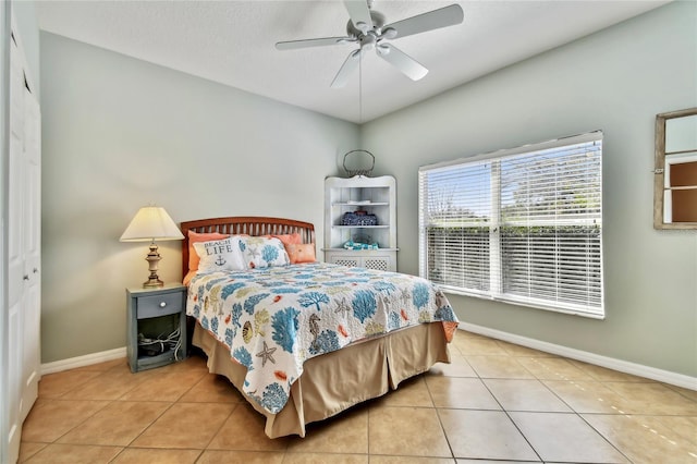 bedroom with light tile patterned floors and ceiling fan