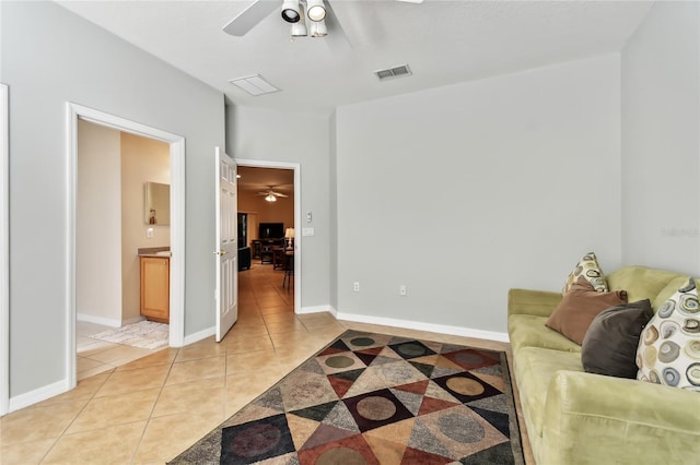 living room featuring light tile patterned flooring and ceiling fan