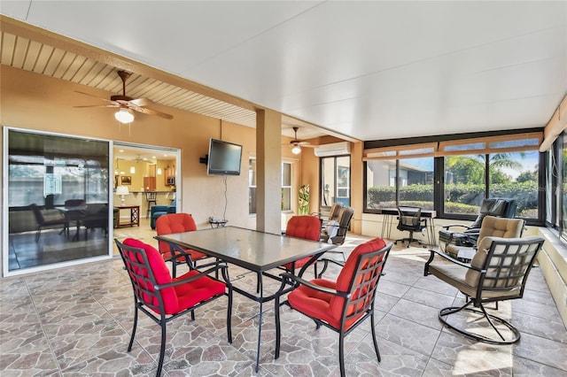 sunroom with ceiling fan and an AC wall unit