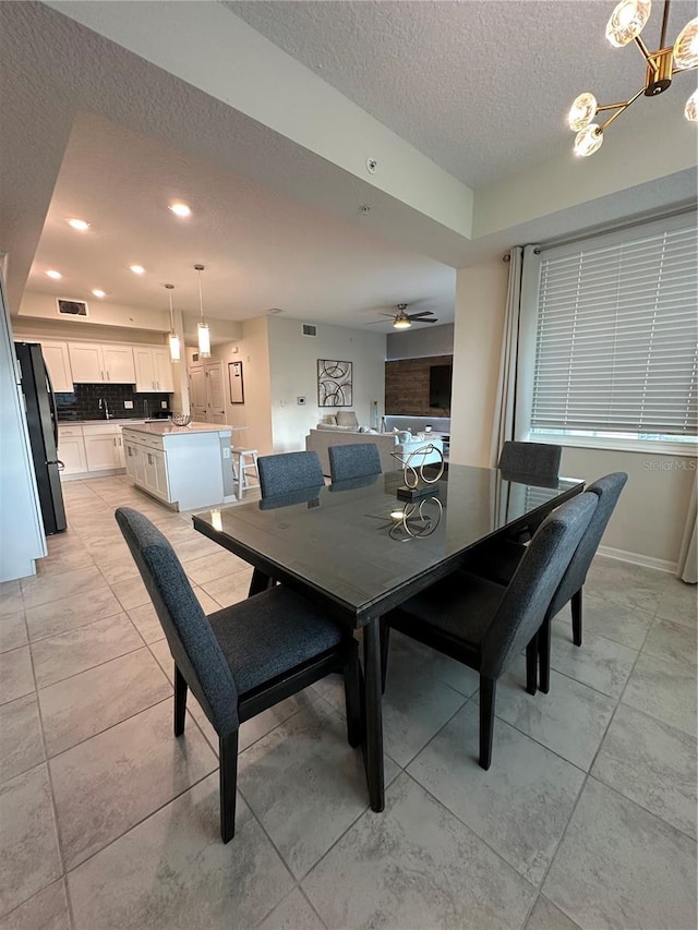 dining space with a textured ceiling, recessed lighting, visible vents, baseboards, and marble finish floor