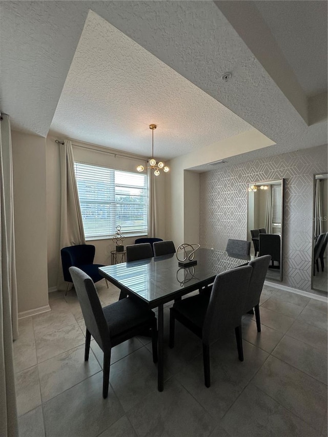 dining space with wallpapered walls, a notable chandelier, baseboards, and a textured ceiling