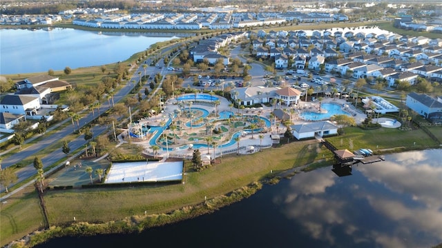 drone / aerial view featuring a water view and a residential view