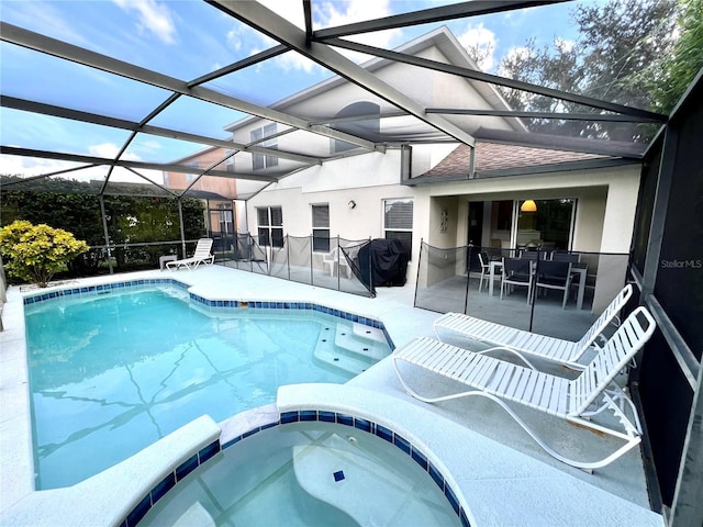 view of swimming pool with a lanai, a patio, and an in ground hot tub