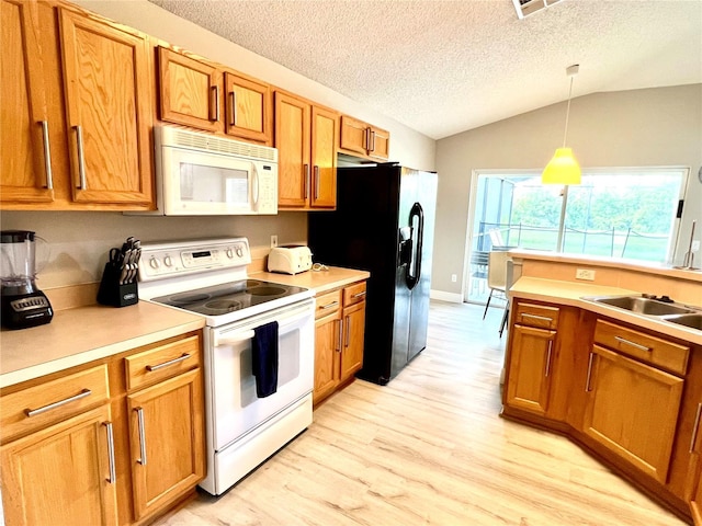 kitchen with vaulted ceiling, hanging light fixtures, white appliances, a textured ceiling, and light wood-type flooring