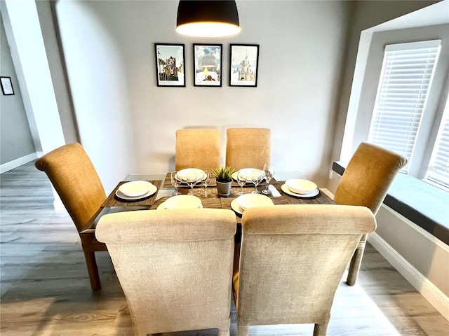 dining area featuring hardwood / wood-style flooring and a healthy amount of sunlight