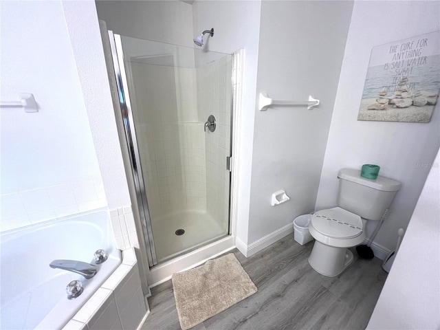 bathroom with separate shower and tub, hardwood / wood-style floors, and toilet