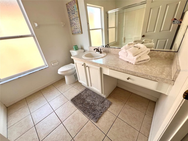 bathroom with tile patterned flooring, vanity, and a wealth of natural light