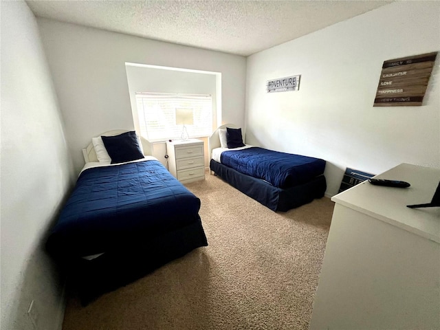 bedroom featuring carpet flooring and a textured ceiling