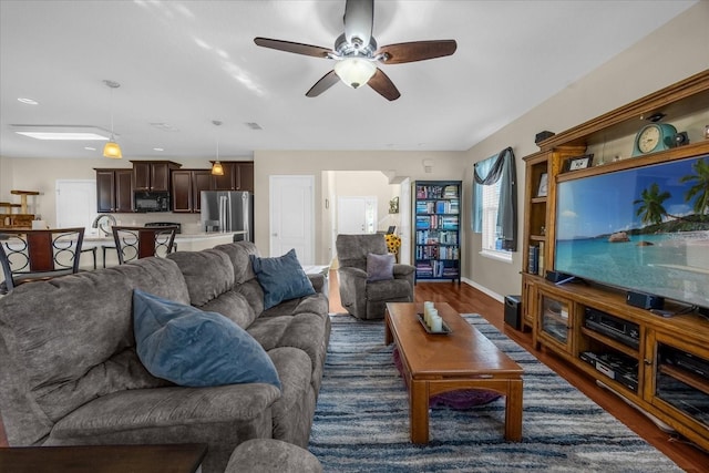 living room featuring dark hardwood / wood-style flooring and ceiling fan